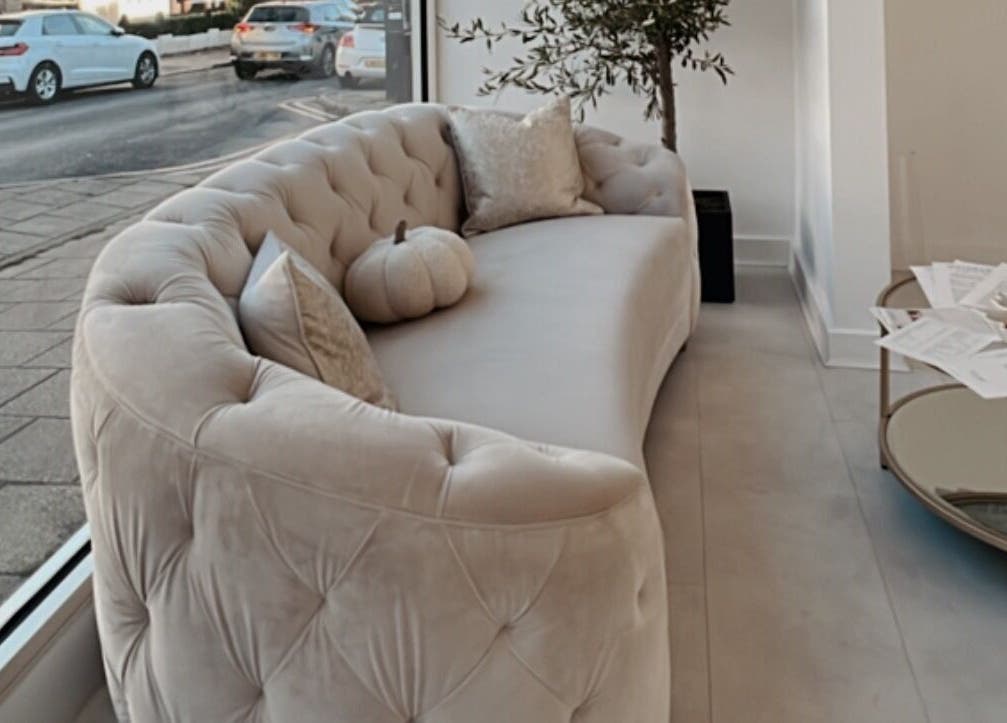 Elegant seating area at Aura Skinn By Sandra, Buckhurst Hill, England, GB with plush sofa and modern decor.