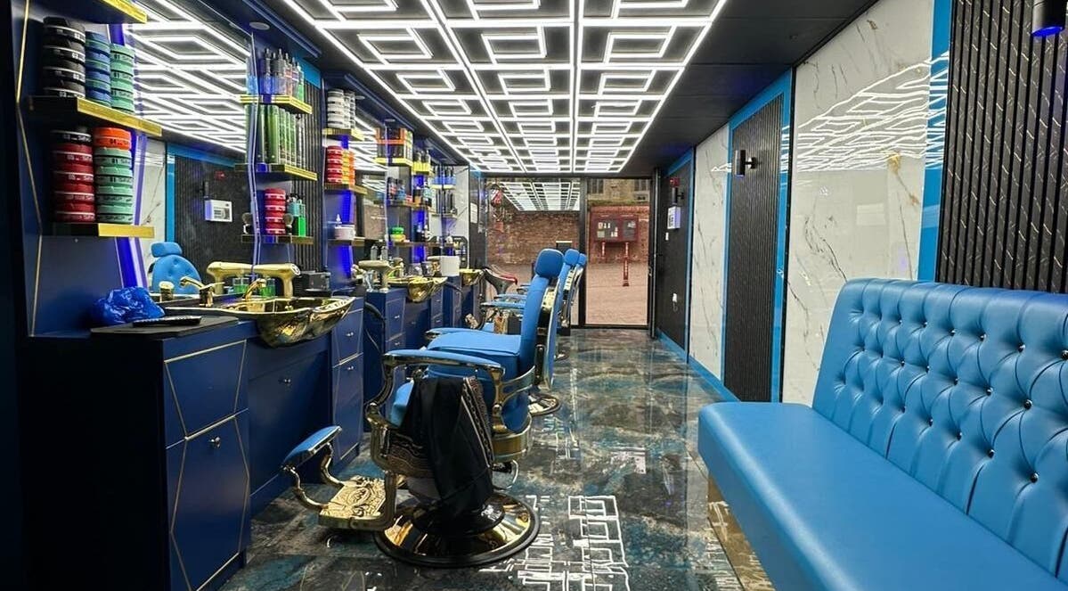Sleek interior of Boss Barber in Ilkeston, England, GB showcasing plush seating and modern decor.