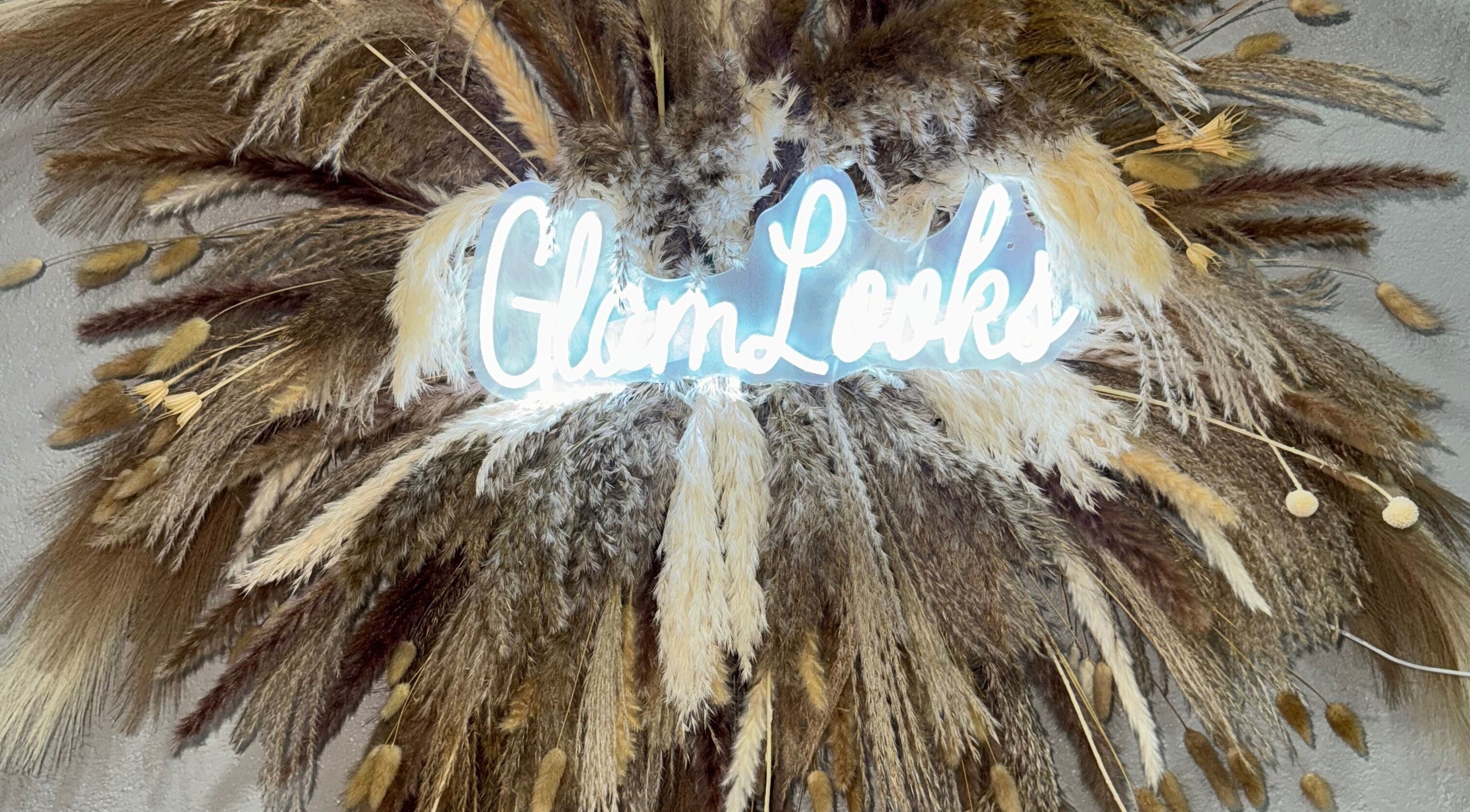 Illuminated Glam Looks sign amid pampas grass at Glam Looks Beauty Salon, Demerara-mahaica, Demerara-mahaica, GY.