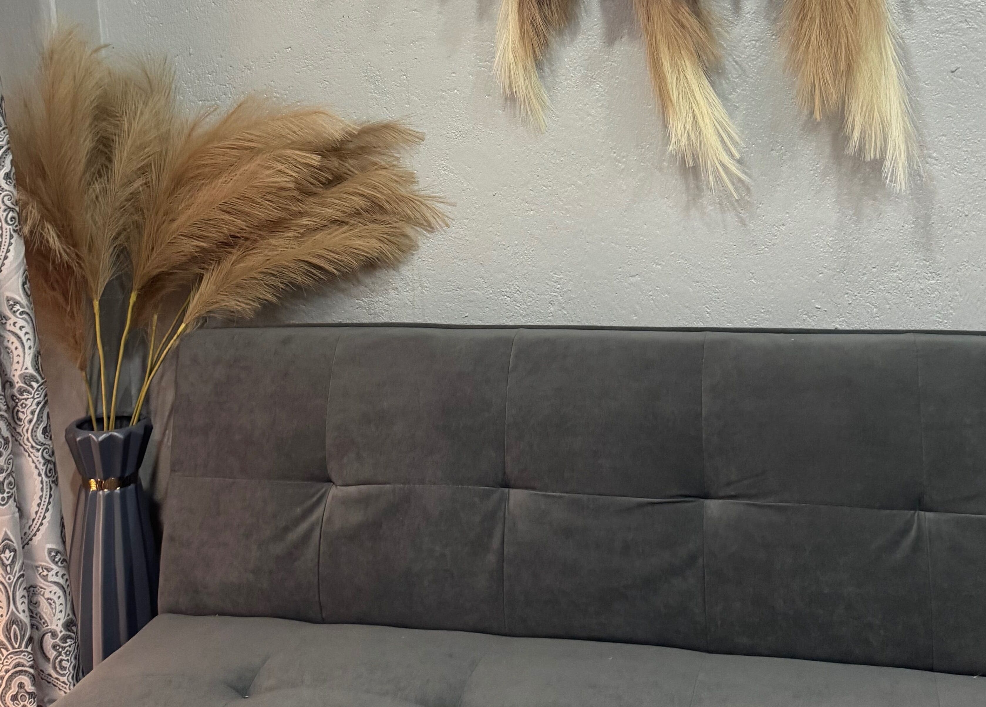 Boho-chic decor at Glam Looks Beauty Salon in Demerara-mahaica, GY, featuring pampas grass and a cozy sofa.
