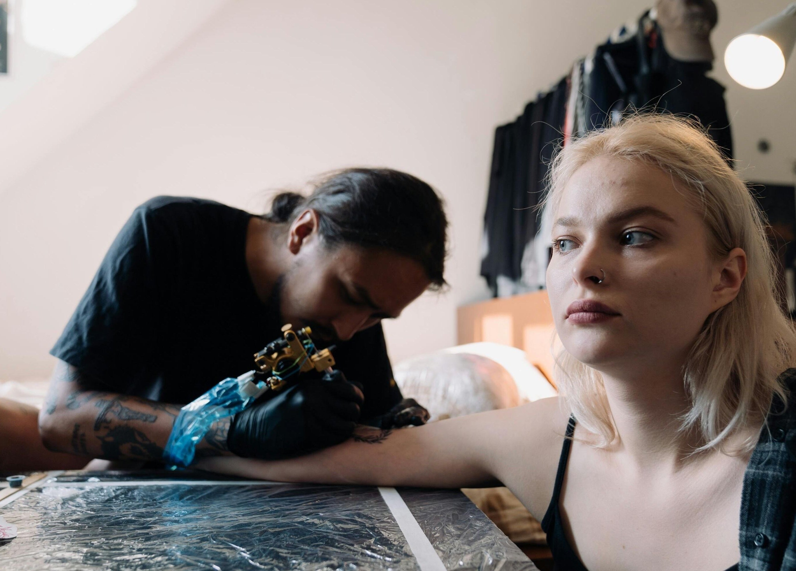 Artist tattooing a woman at DUSTIN LITTLES TATTOOS in Harmony, North Carolina, US.