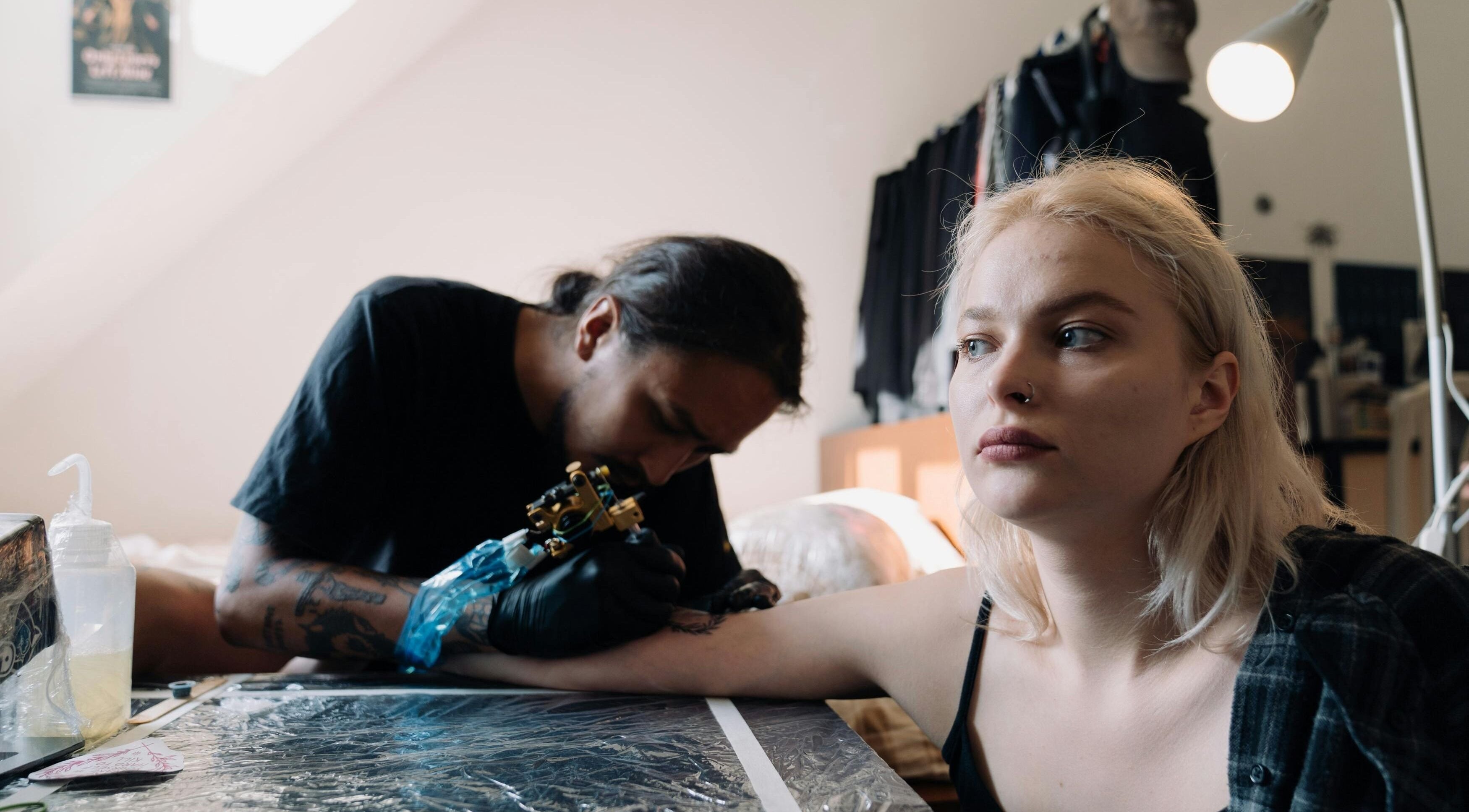 Artist tattooing a woman at DUSTIN LITTLES TATTOOS in Harmony, North Carolina, US.