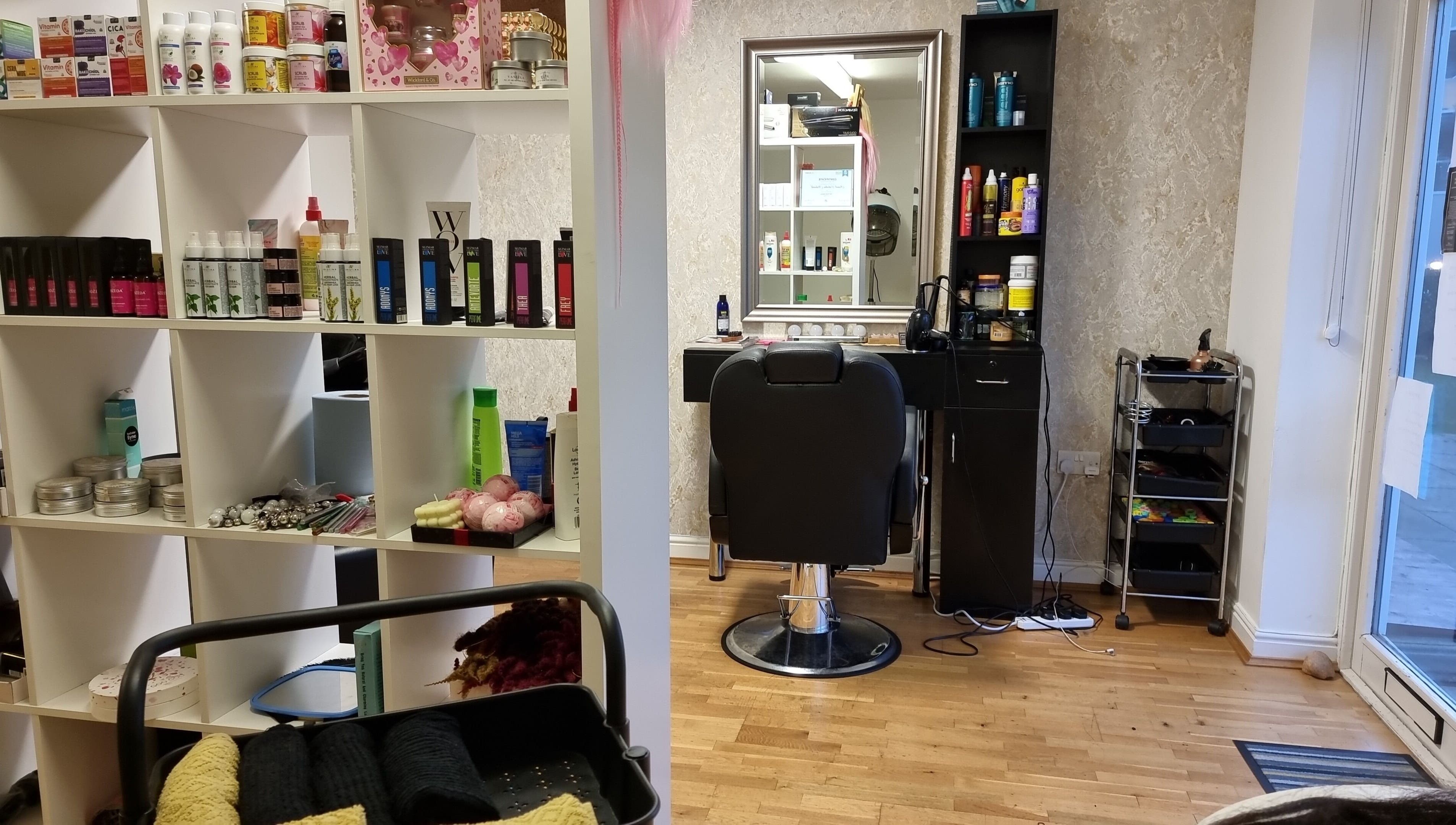 Hairbysaven#Savenwest salon interior at Ipswich, England, GB featuring stylish chair and product shelves.