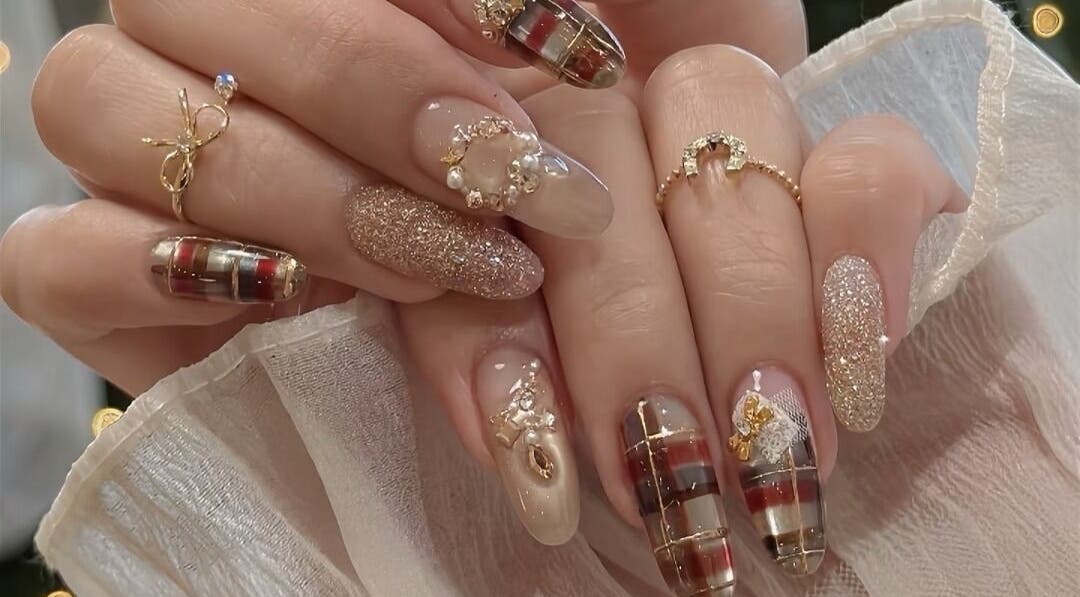 Intricate nail art with glitter and embellishments at Lumie Aure Beauty Studio in Ottawa, Ontario, CA.