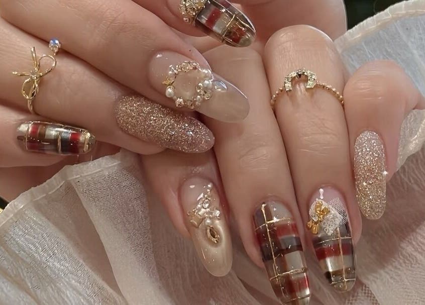Elegant nail art with gold and plaid design at Lumie Aure Beauty Studio in Ottawa, Ontario, CA.