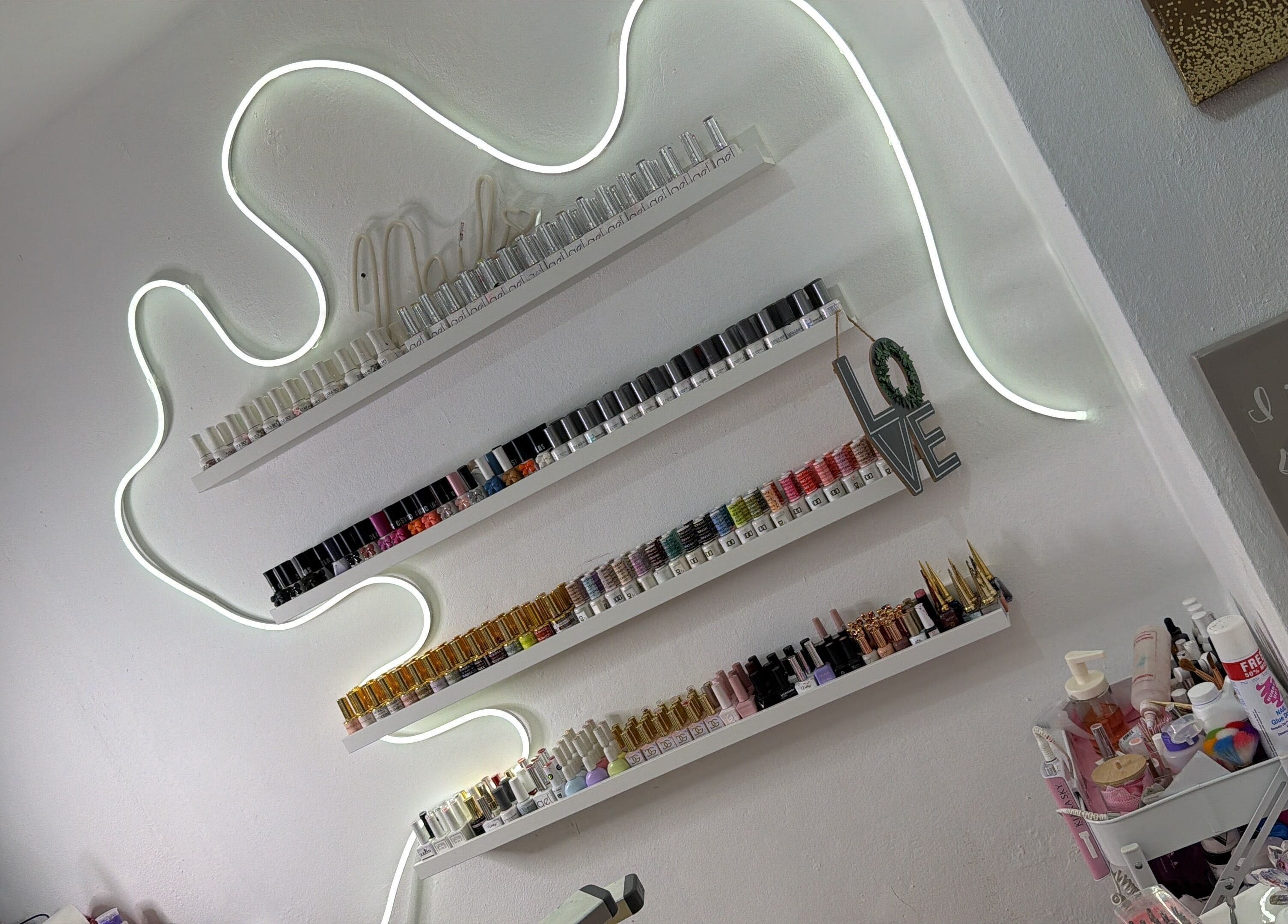 Elegant nail polish shelves at Nails by rossy, Santiago De Los Caballeros, Santiago, DO enhance the ambiance.