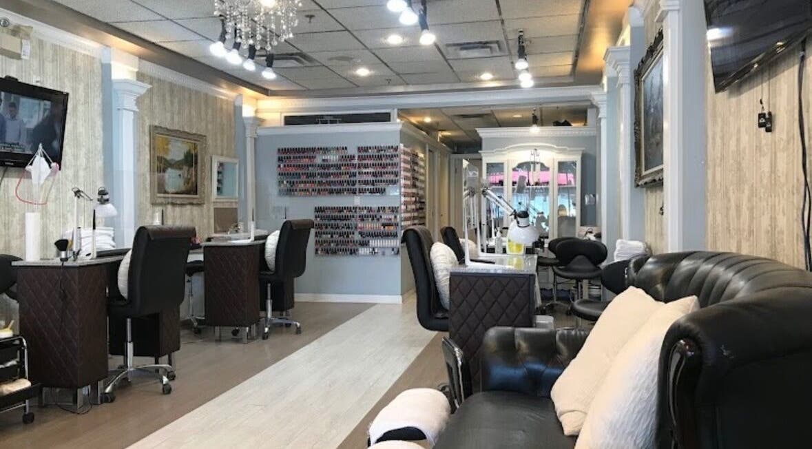 Interior of Magnifique Nail Spa, Vancouver, BC, CA featuring stylish seating and nail stations.