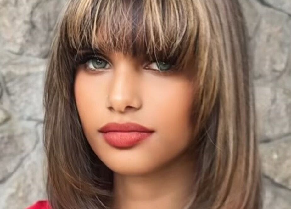Elegant hairstyle showcased at Le Studio De Malik, Paramaribo, Paramaribo, SR, against a stone backdrop.