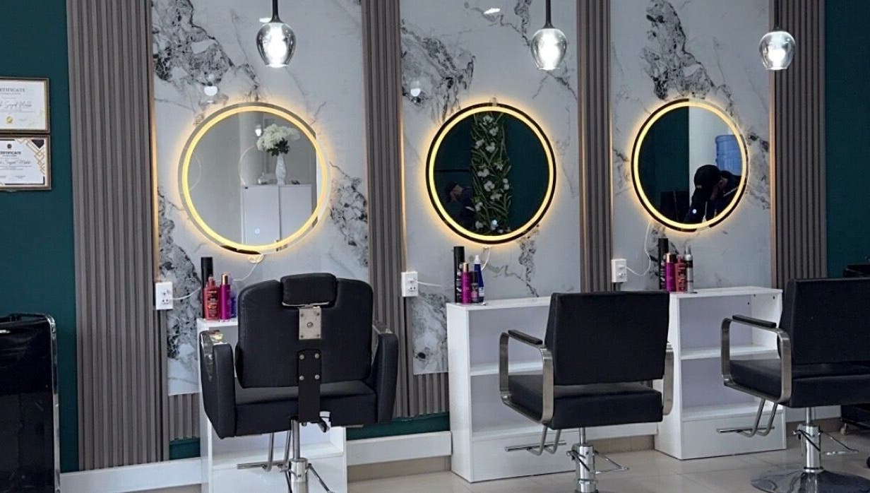 Elegant salon interior with illuminated mirrors at Le Studio De Malik, Paramaribo, Paramaribo, SR.