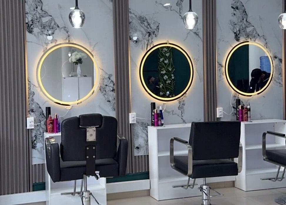 Elegant salon interior with illuminated mirrors at Le Studio De Malik, Paramaribo, Paramaribo, SR.