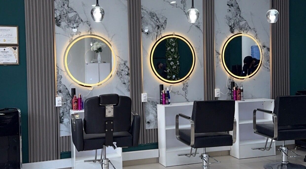 Elegant salon interior with illuminated mirrors at Le Studio De Malik, Paramaribo, Paramaribo, SR.