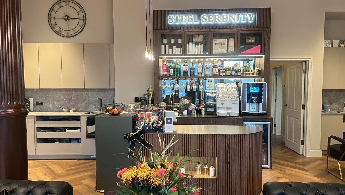 Aster Beauty at Steel Serenity's elegant bar area in Fakenham, England, offering premium refreshments.