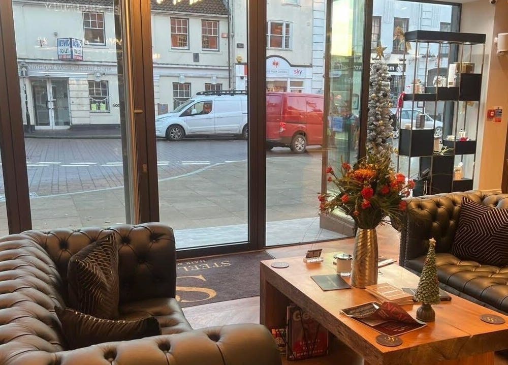 Modern lounge at Aster Beauty at Steel Serenity, Fakenham, England, GB featuring stylish sofas and decor.