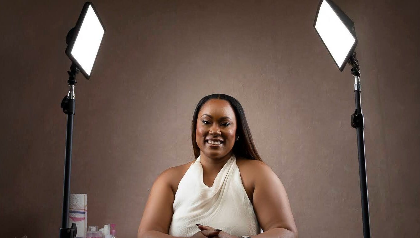 Beauty specialist at The Soft Edit- Lashes & Brows in Kingston, St. Andrew Parish, JM, smiling under studio lights.