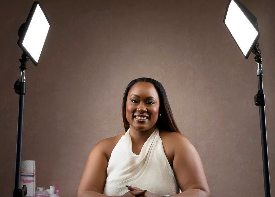 Beauty specialist at The Soft Edit- Lashes & Brows in Kingston, St. Andrew Parish, JM, smiling under studio lights.