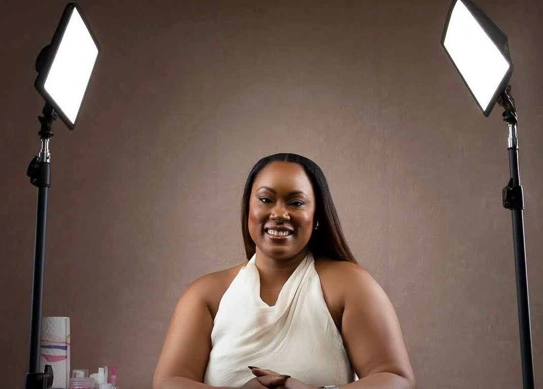 Beauty specialist at The Soft Edit- Lashes & Brows in Kingston, St. Andrew Parish, JM, smiling under studio lights.