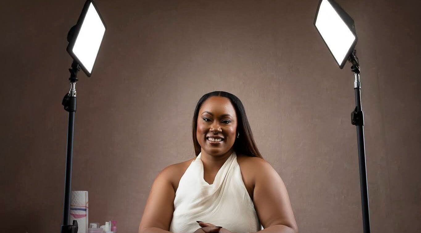 Beauty specialist at The Soft Edit- Lashes & Brows in Kingston, St. Andrew Parish, JM, smiling under studio lights.