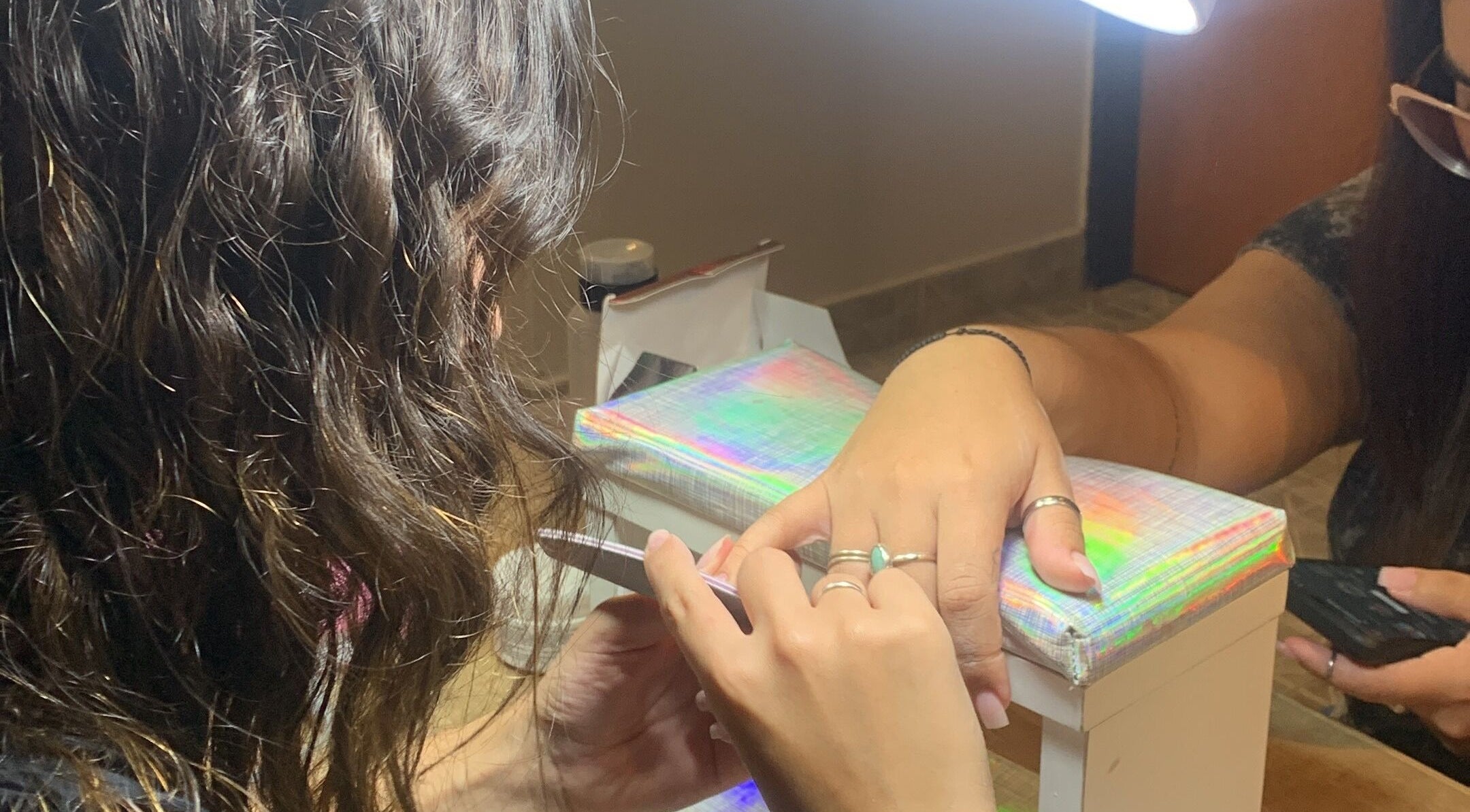 Mujer recibiendo manicura en CM Braids, Tapiales, Provincia De Buenos Aires, AR.
