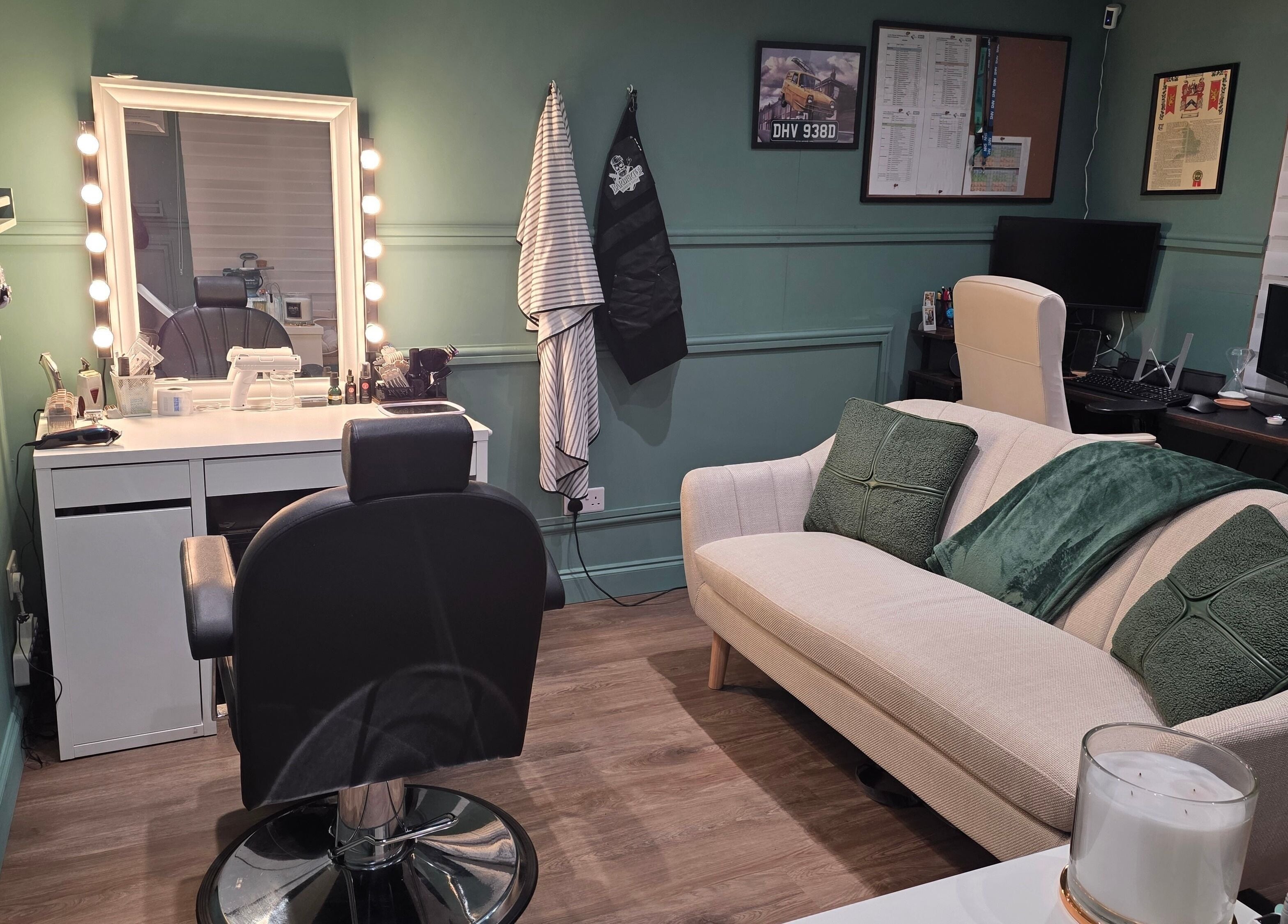 Cozy and stylish interior of The Green Room Barbers, Leeds, England, GB, featuring a well-lit mirror and seating area.