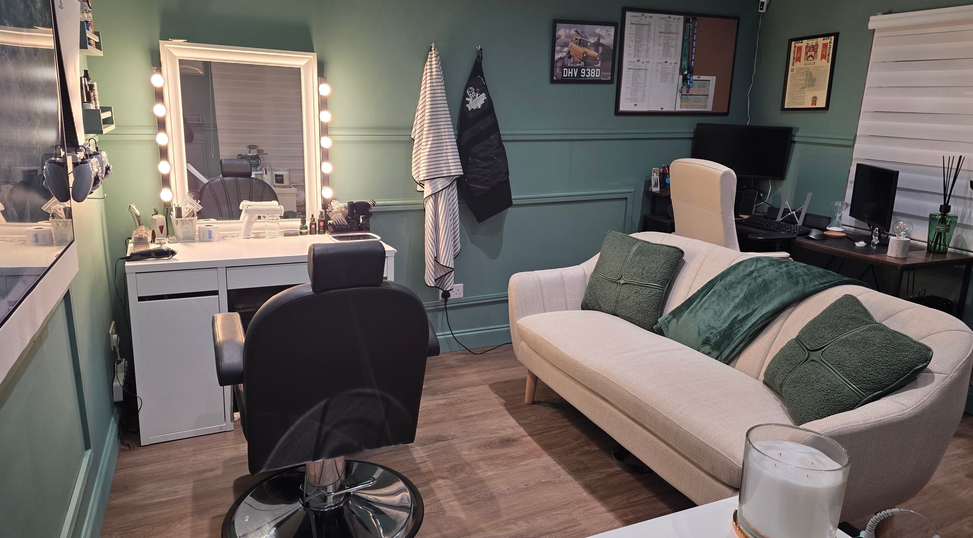 Cozy and stylish interior of The Green Room Barbers, Leeds, England, GB, featuring a well-lit mirror and seating area.