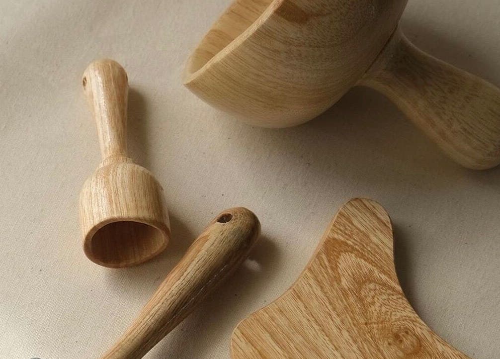 Natural wooden spa tools at Sculpt Studio in CA, perfect for wellness treatments.