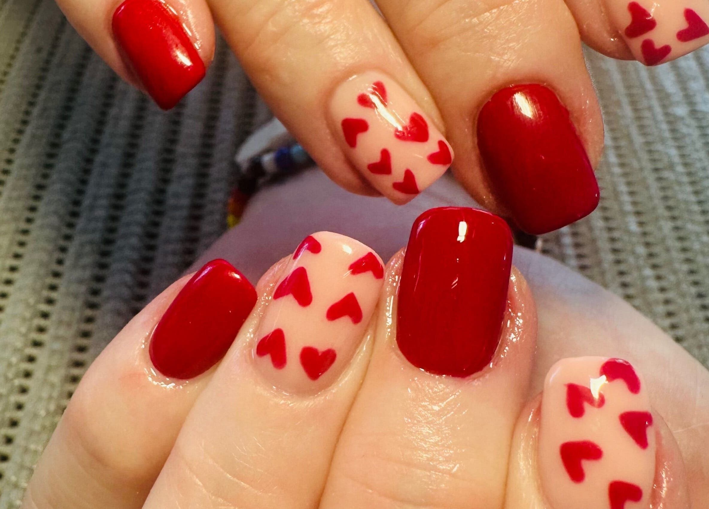 Elegant red and heart-accented nails at Lux-glomournails, Cape Town, Western Cape, ZA.