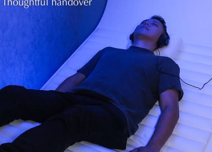 Person relaxing in a futuristic pod at Be Earth Wellness, Hong Kong Island, HK.