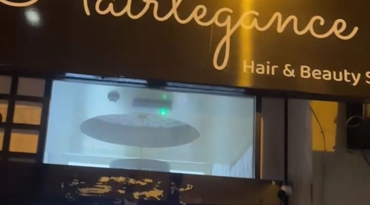 Exterior of Hairlegance salon in Newcastle upon Tyne, England, GB, showcasing the modern sign and window.