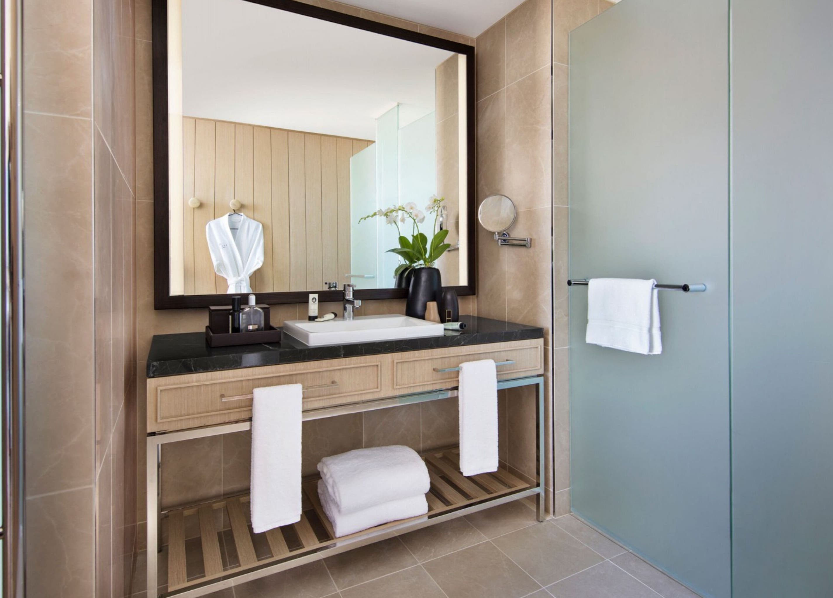 Luxurious bathroom at In-Room - Sofitel, Sydney, New South Wales, AU with elegant decor and plush amenities.