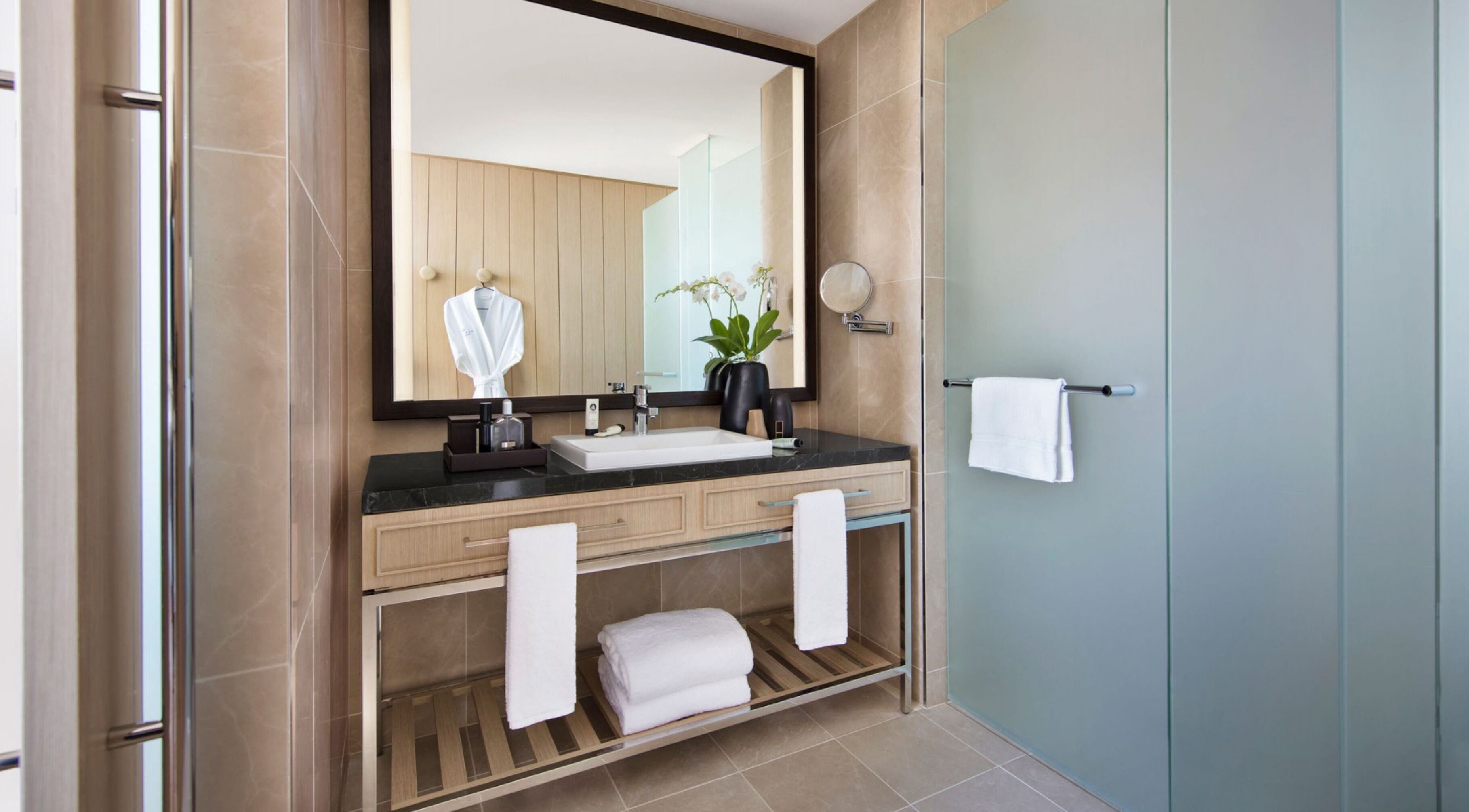 Luxurious bathroom at In-Room - Sofitel, Sydney, New South Wales, AU with elegant decor and plush amenities.