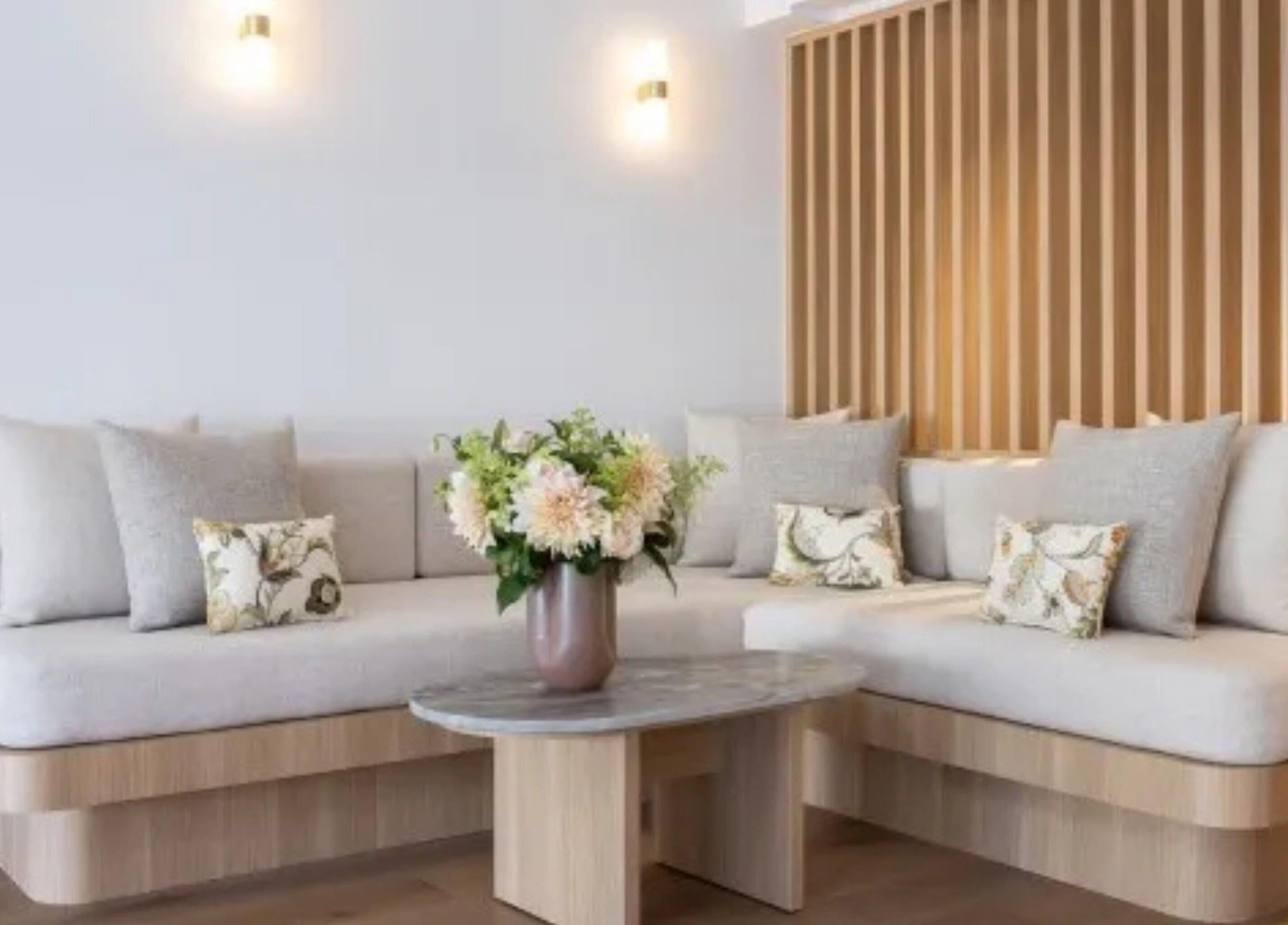 Elegant lounge area at Sofitel Spa, Sydney, New South Wales, AU with plush seating and flowers.