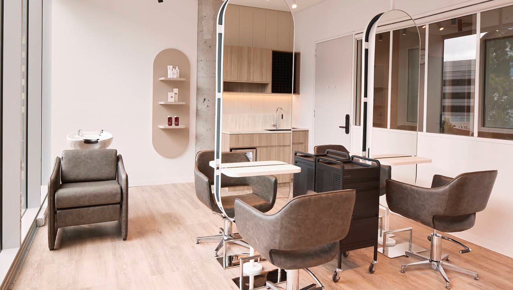 Modern salon interior at Salon Lane, St Leonards, New South Wales, AU with stylish chairs and large mirrors.