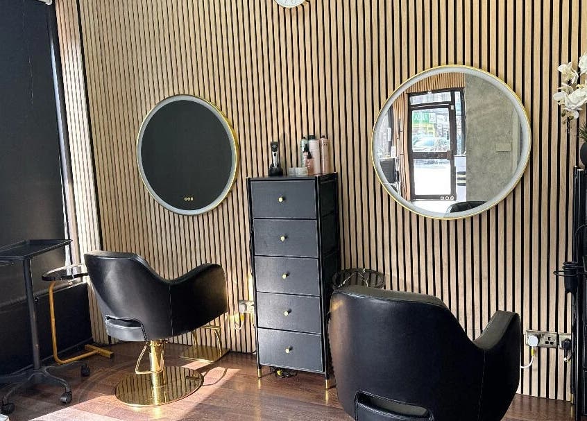 Chic salon interior at Nuvia Beauty London, London, England, GB with modern chairs and mirrors.