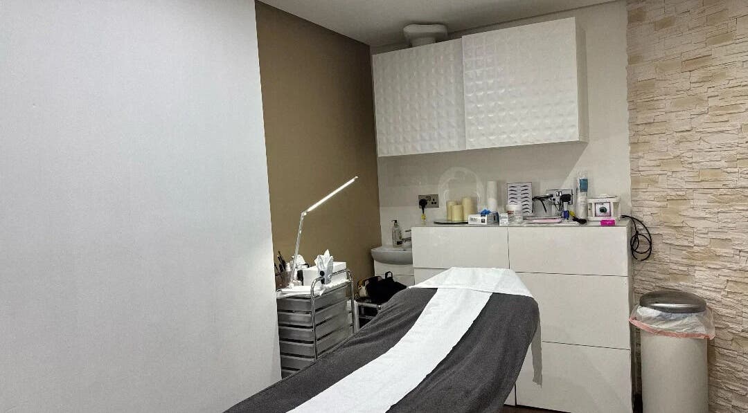 Serene treatment room at Nuvia Beauty London, featuring modern decor and a massage bed. London, England, GB.