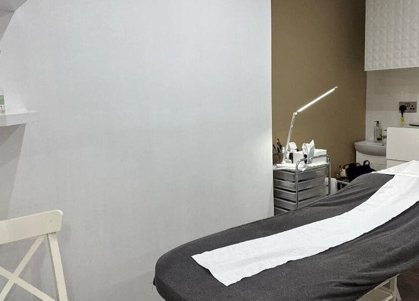 Relaxing treatment room at Nuvia Beauty London, London, England, GB, featuring a comfortable massage table.