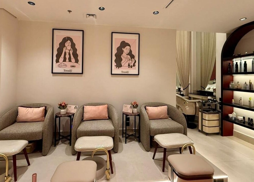 Cozy seating area in Tressy Spa, Riyadh, Riyadh Province, SA, showcasing elegant decor and beauty product shelves.