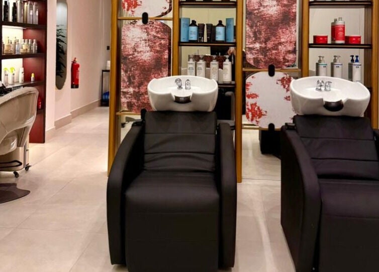 Modern hair wash station at Tressy Spa, Riyadh, Riyadh Province, SA, featuring sleek black chairs.