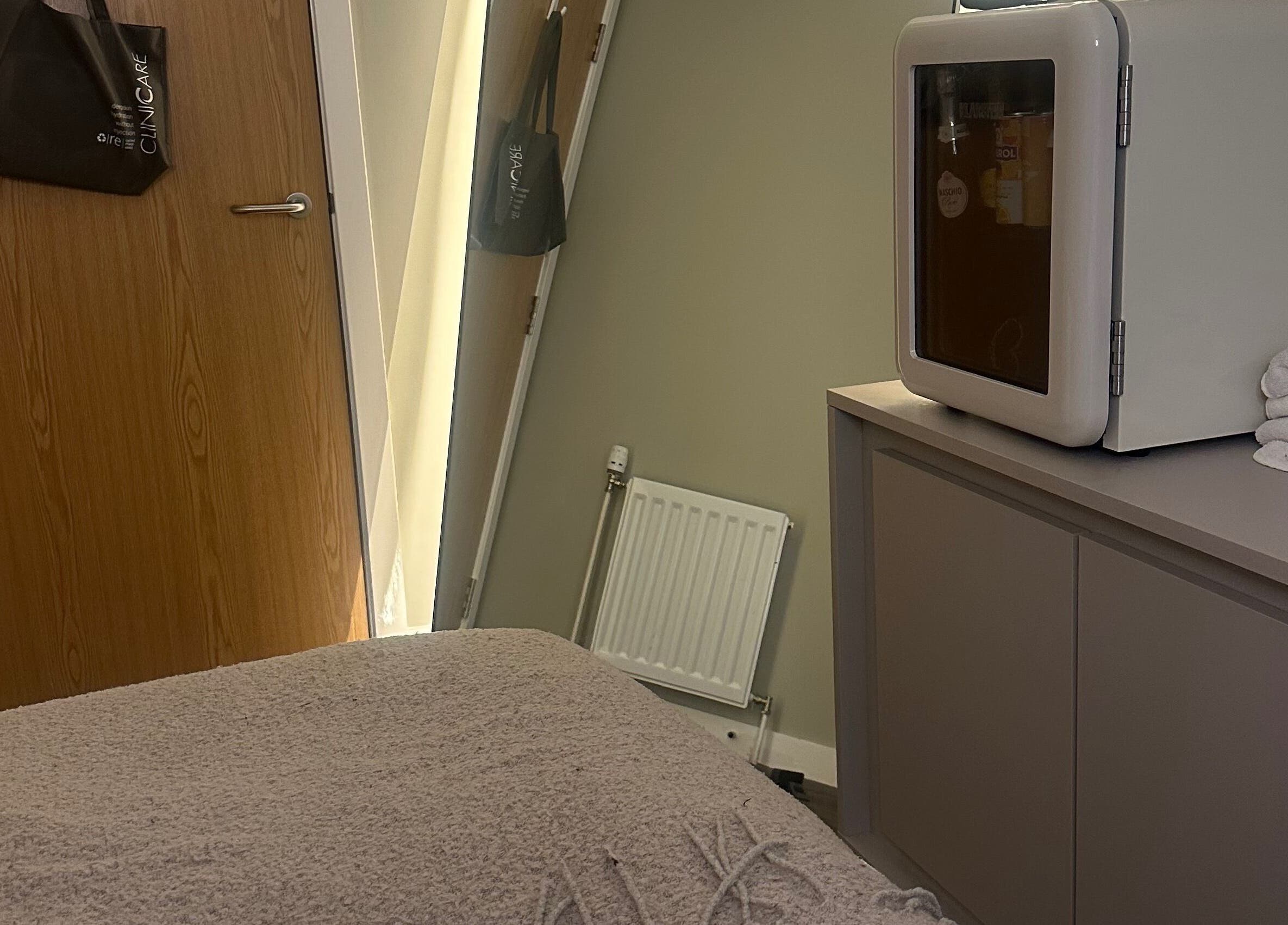 Cozy treatment room at Face, Lash & Brow, Glasgow, Scotland, GB with soft lighting and elegant decor.