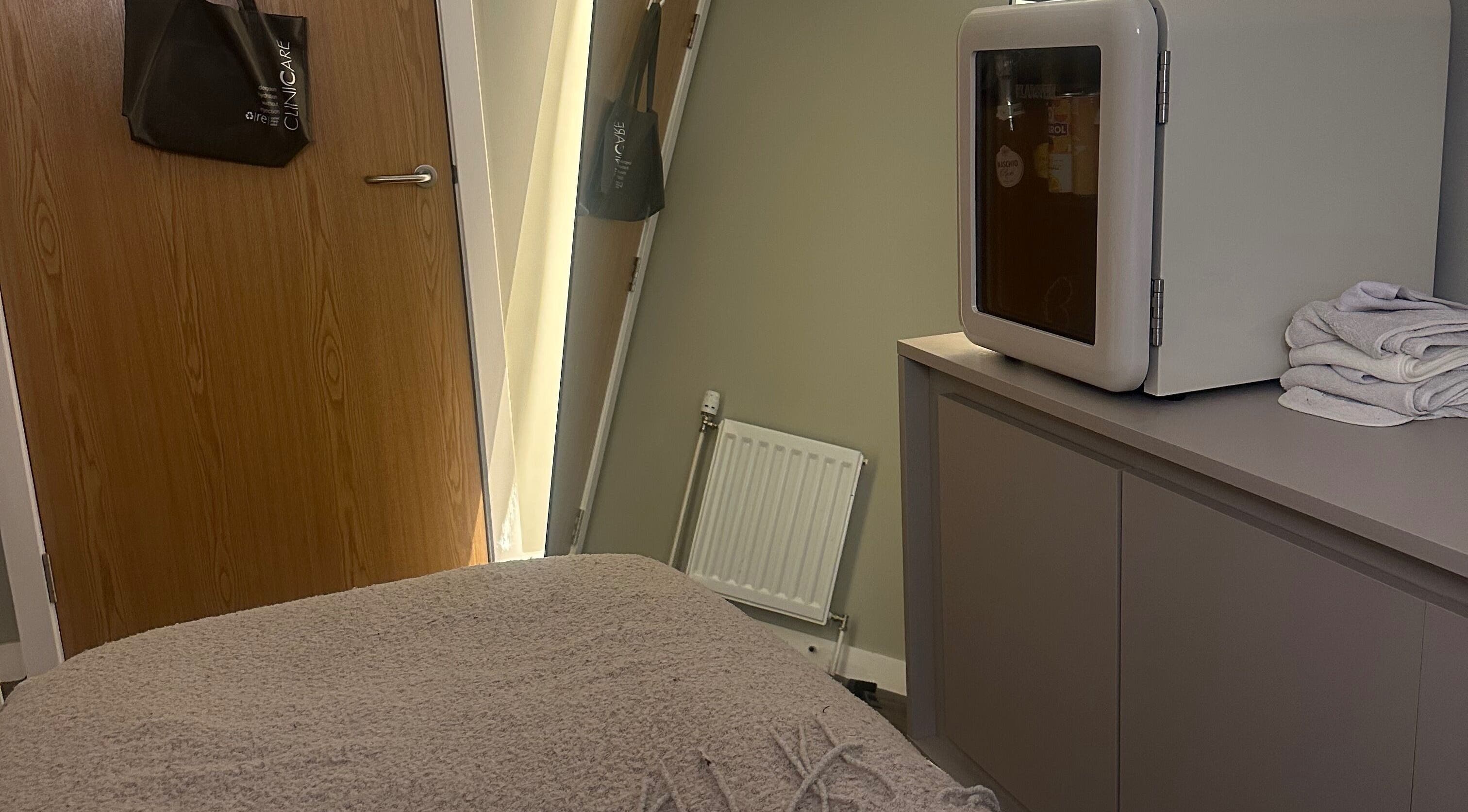 Cozy treatment room at Face, Lash & Brow, Glasgow, Scotland, GB with soft lighting and elegant decor.