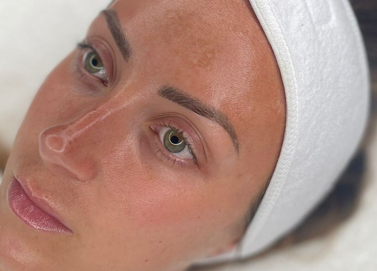 Close-up of a calm face with glowing skin at Face, Lash & Brow, Glasgow, Scotland, GB.