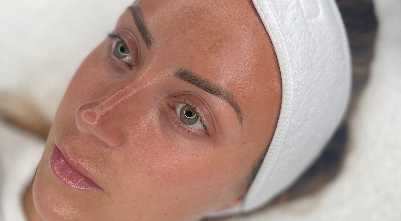 Close-up of a calm face with glowing skin at Face, Lash & Brow, Glasgow, Scotland, GB.