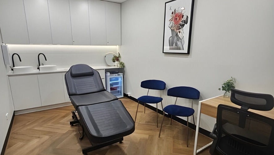 Modern treatment room at Aestha Skin, Melbourne, Victoria, AU, with reclining chair and sleek decor.