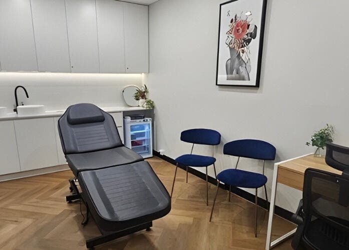 Modern treatment room at Aestha Skin, Melbourne, Victoria, AU, with reclining chair and sleek decor.