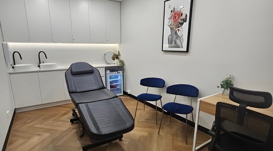 Modern treatment room at Aestha Skin, Melbourne, Victoria, AU, with reclining chair and sleek decor.