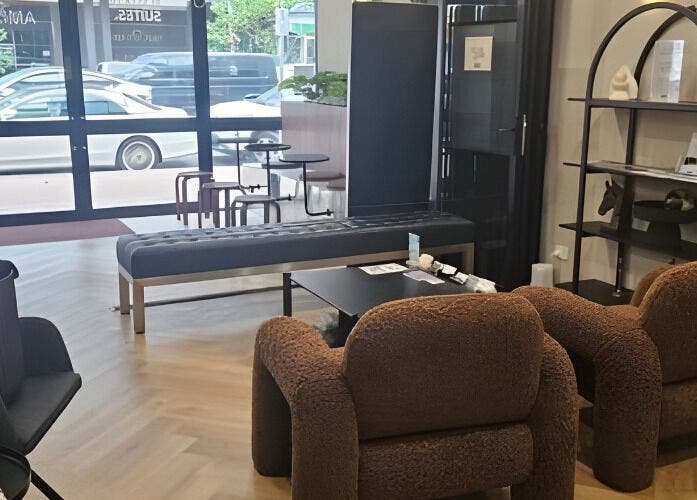 Cozy salon seating at Aestha Skin, Melbourne, Victoria, AU with plush chairs and modern decor.
