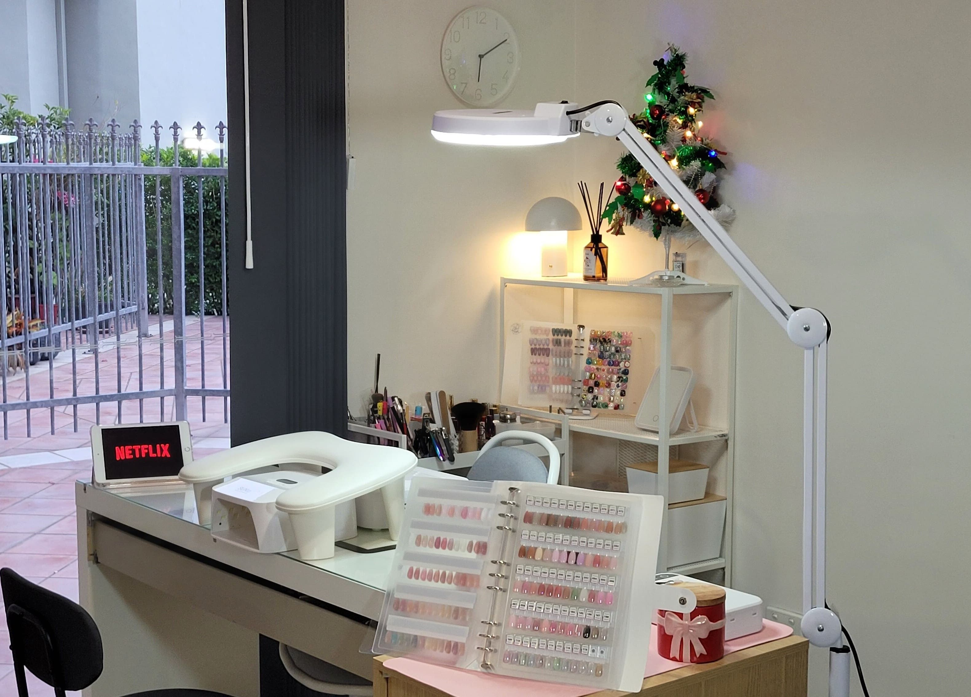 Cozy manicure station at Natural Hues, Yeronga, Queensland, AU with nail polish display and modern decor.