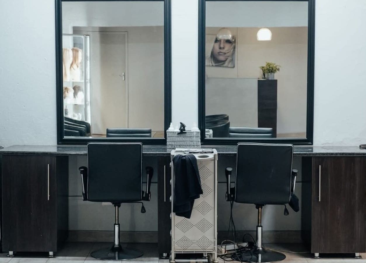 Modern salon workspace at Celicia's Hair Studio in Vereeniging, Gauteng, ZA with sleek chairs and mirrors.