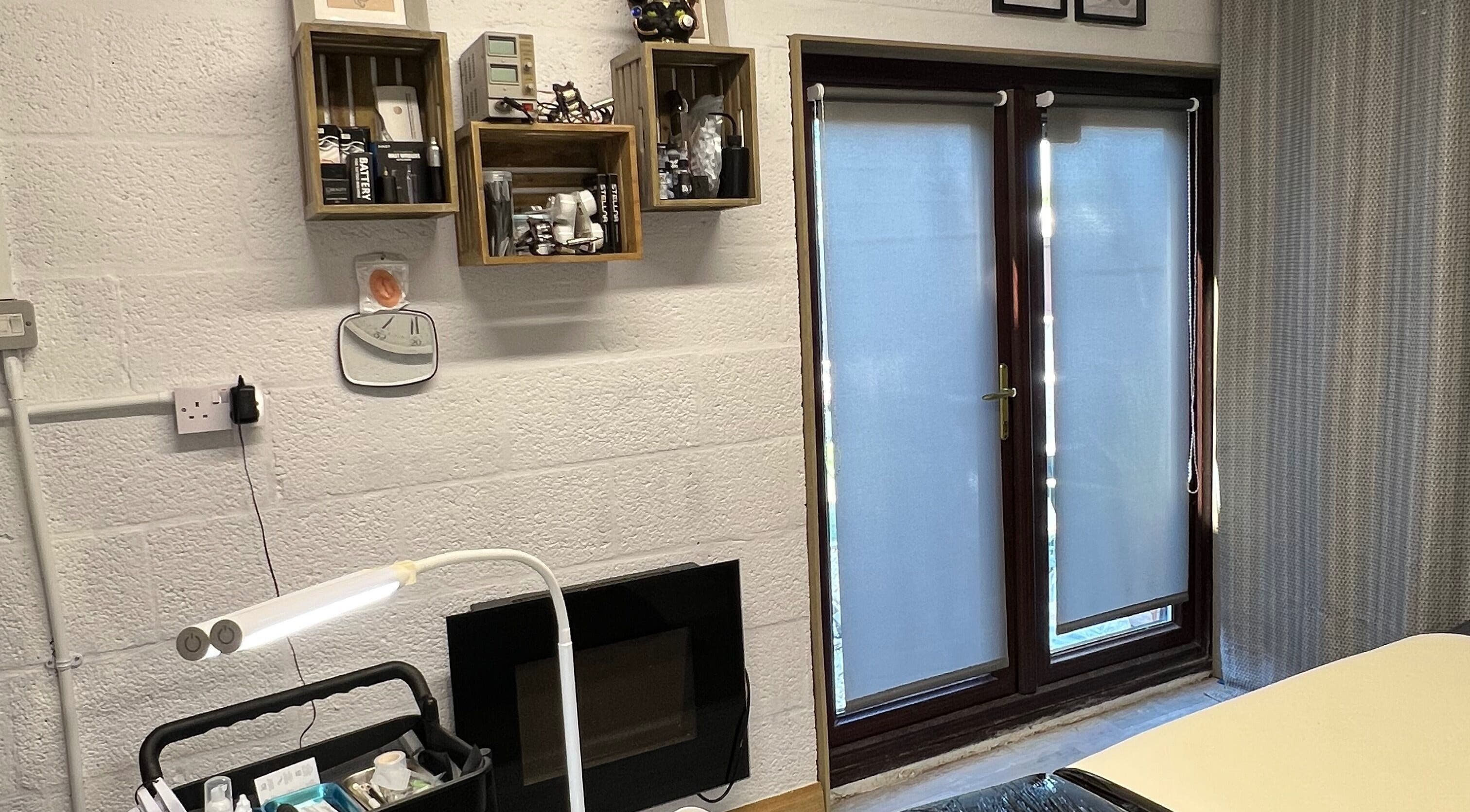 Calm interior of The Studio Aesthetic Canvas in Market Drayton, England with shelves and soft lighting.