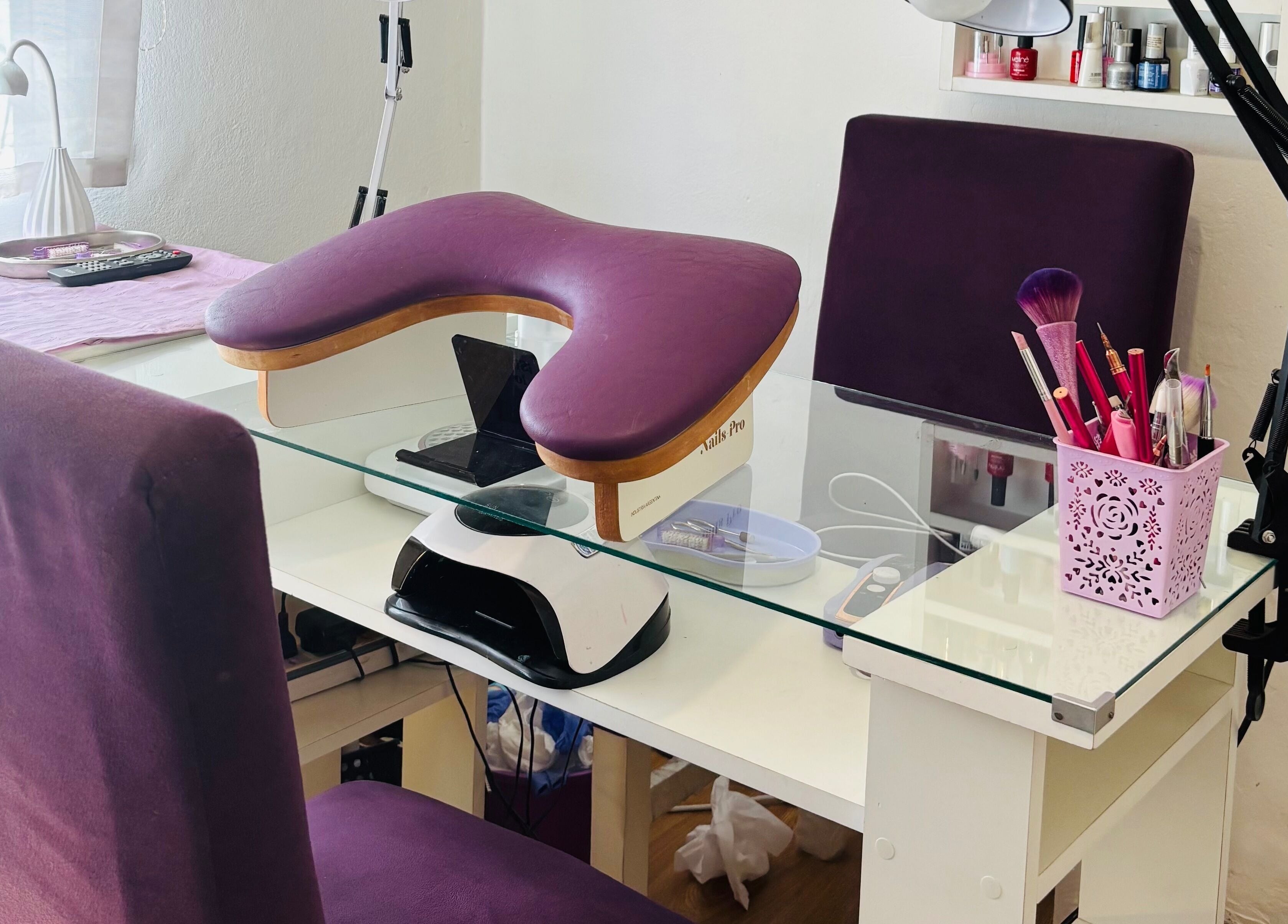Estación de uñas en Aura nails, Villa Ballester, Buenos Aires. Mesa blanca con asiento púrpura y herramientas de manicura.