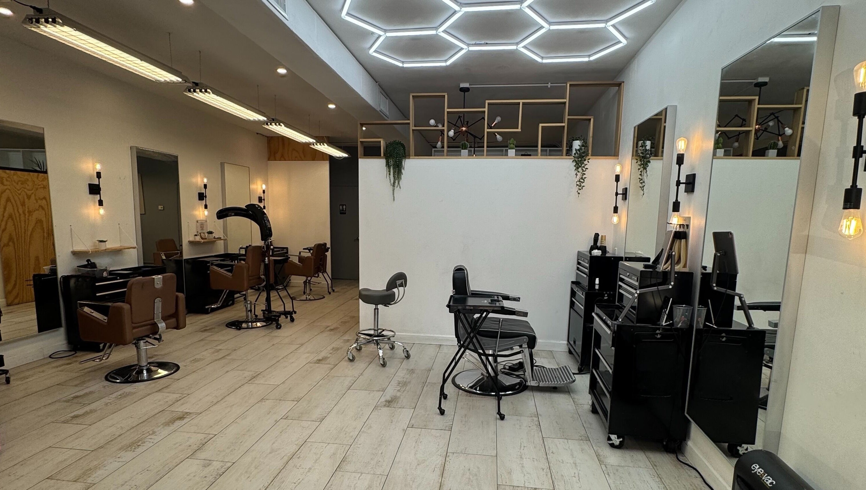 Interior of Hair Lab Studio Salon in Fort Lauderdale, FL, US featuring stylish chairs and contemporary lighting.
